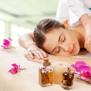 Masseur doing massage on woman body in the spa salon. Beauty tre Masseur doing massage on woman body in the spa salon. Beauty treatment concept.